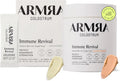 ARMRA Colostrum Immune Revival powder supplement packaging shown on a white background, including a large tub, a smaller box, a single sachet, a yellow 'Sourced & Made in the USA' badge, and two powder swatches in pale yellow and peach.