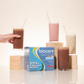 Biocare dietary beverage packaging with glasses of the product on a light background