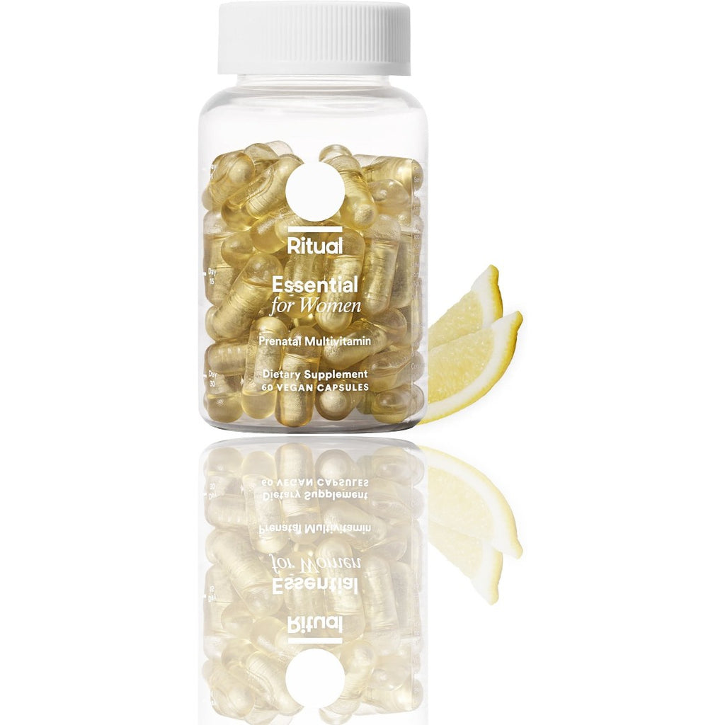 Supplement bottle labeled 'Ritual Essential for Women' with a lemon wedge on a white background